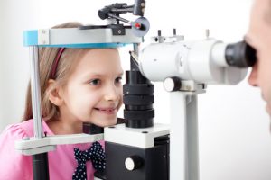 Young girl patient is having a medical attendance at the optometrist.