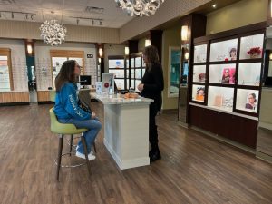 An optometric assistant helps a patient in our optical